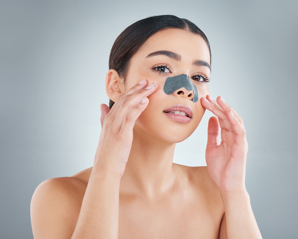 Woman, nose strip and portrait in studio for skincare.