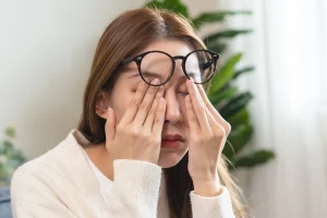 Eye problem concept, fatigue asian young woman tired eyes